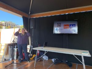 A photo of Pilar Orero presenting ImAc in the Live better live more tent